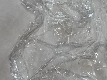 Close up of an Enki disposable hair cutting cape.