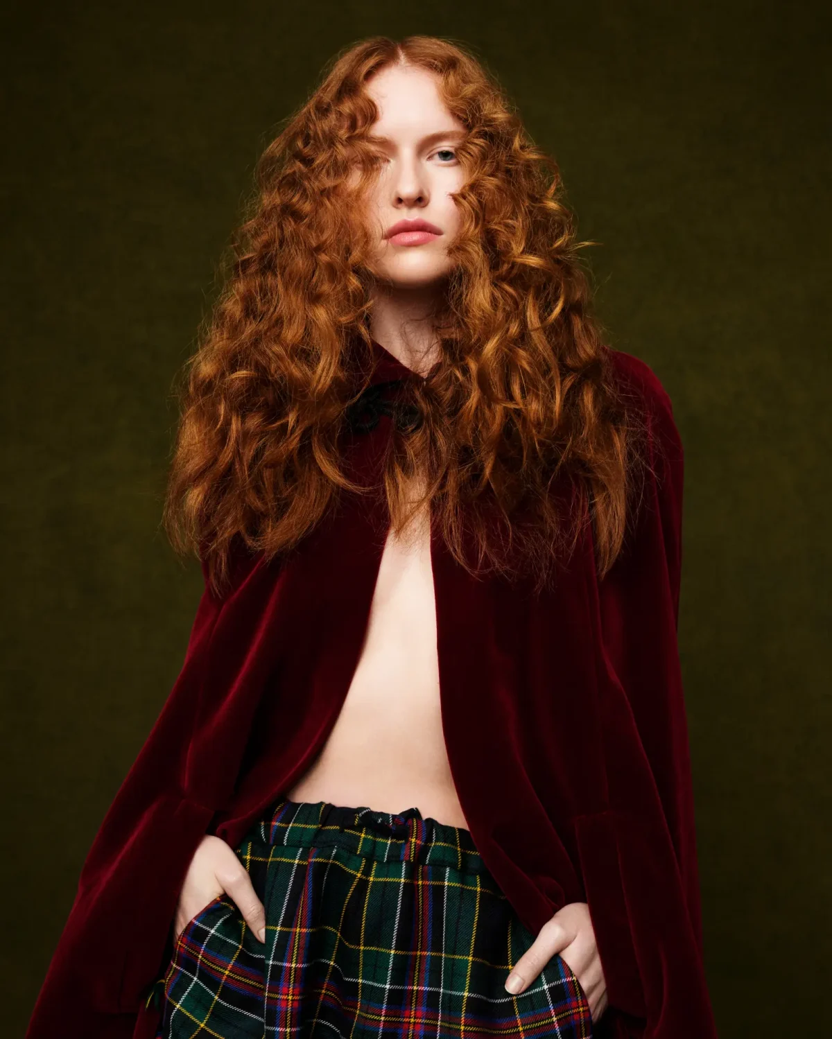 Fashion portrait featuring long, voluminous copper curls inspired by 80s hair trends, styled with texture, movement and editorial flair.