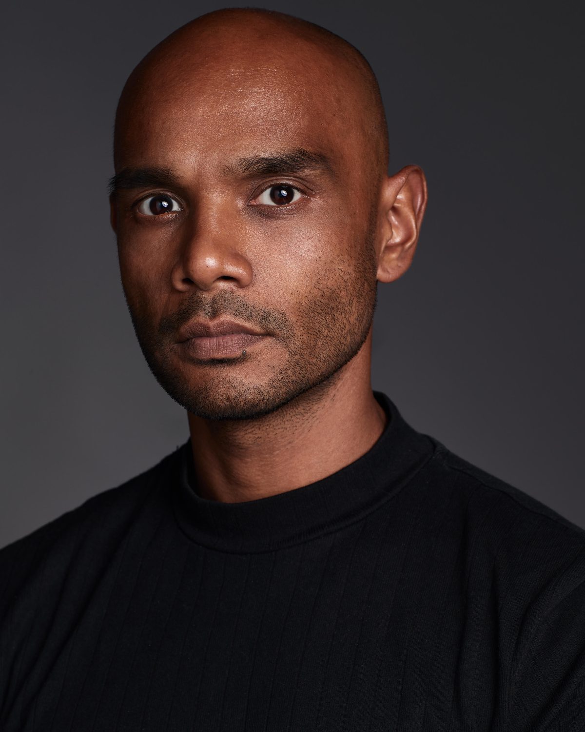Portrait of Kevin Luchmun, award-winning barber, educator and men's hair specialist, known for modern cutting techniques and barbering expertise.