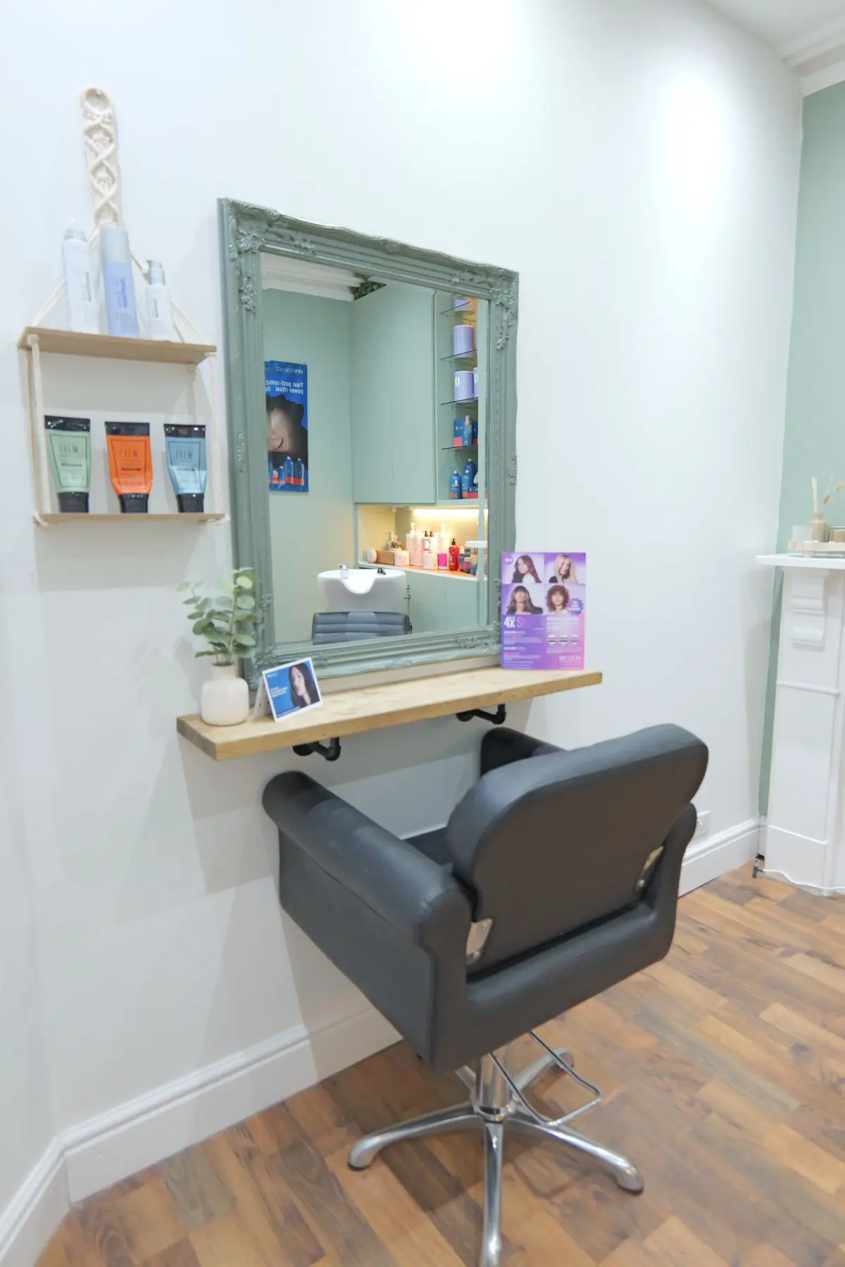Salon swivel chair next to a vintage painted mirror in the Lukas Payne salon.