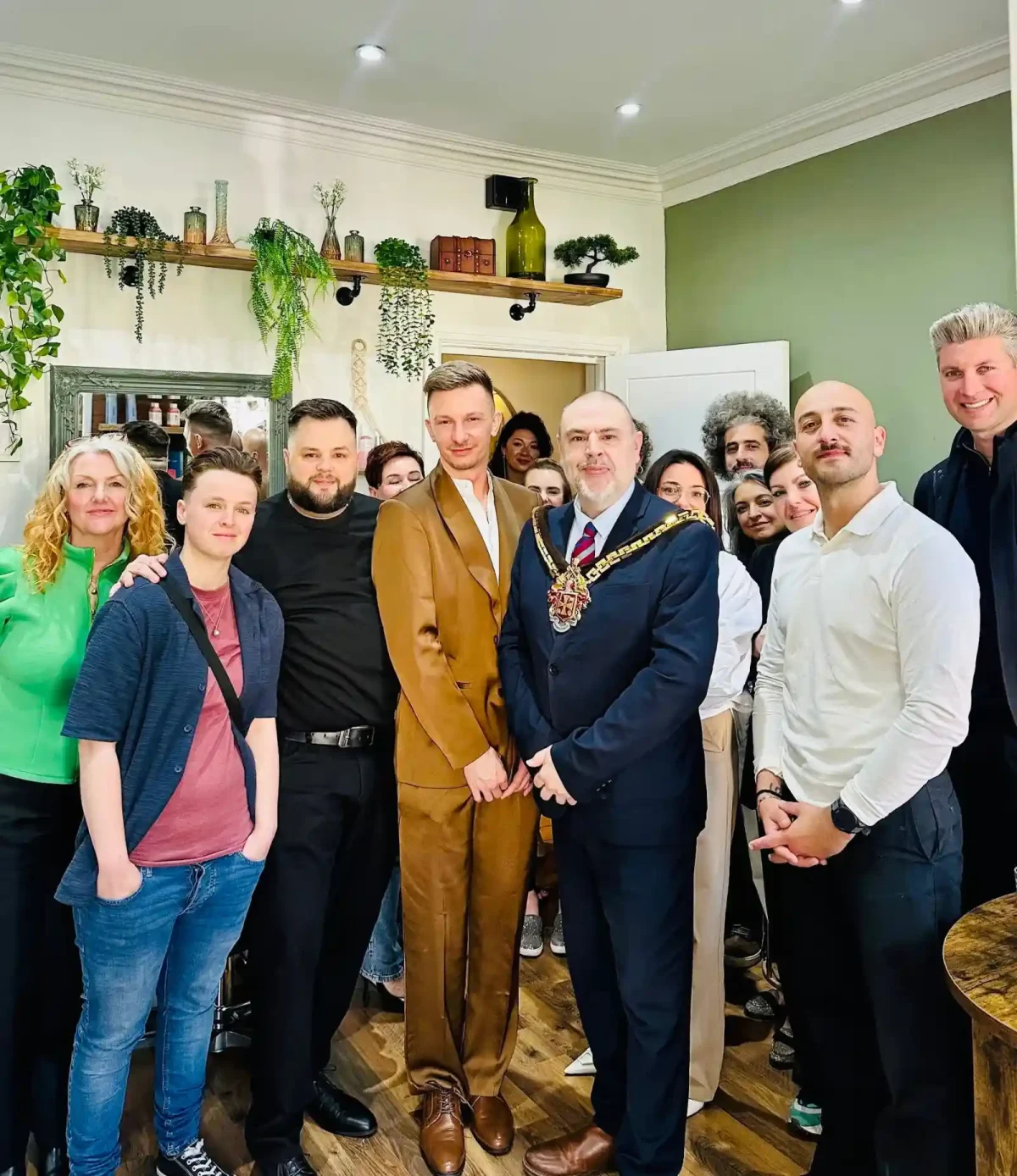 Lukas Payne and salon team members stand with the Major inside the new salon.