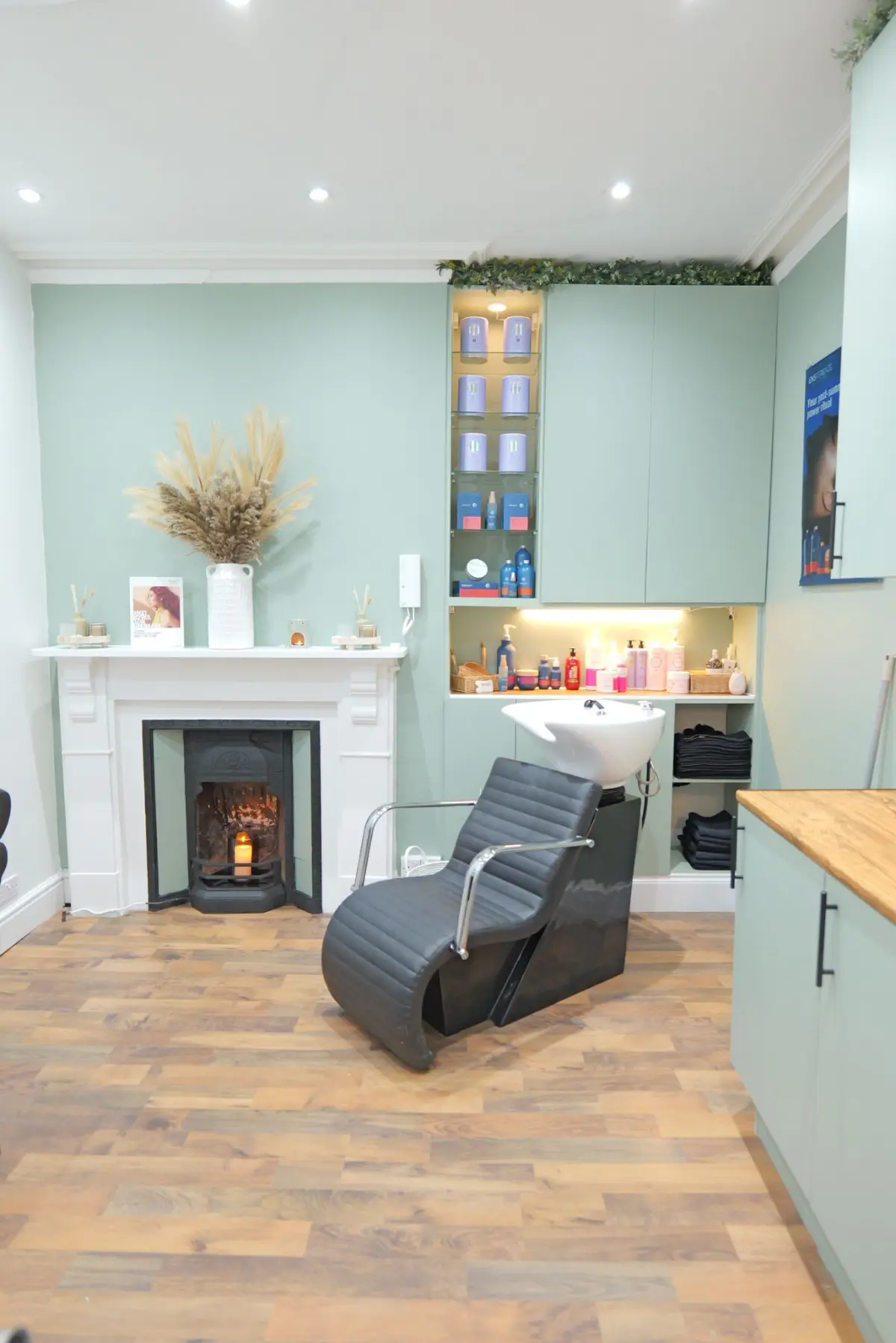 Salon backwash by a vintage fire place with a lit candle.