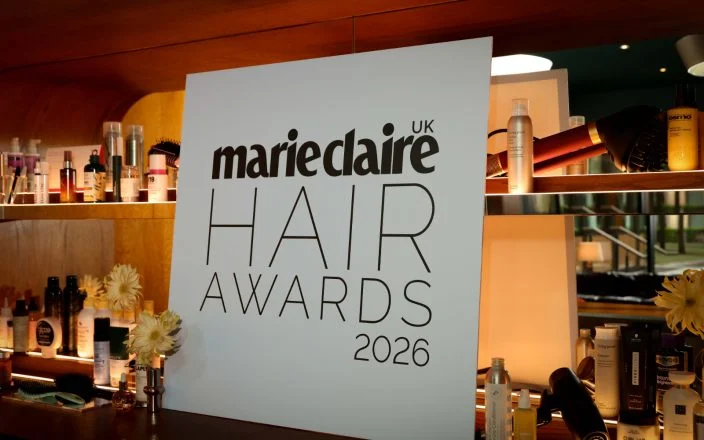 A black and white Marie Claire Hair Awards 2026 sign stands on a bar.