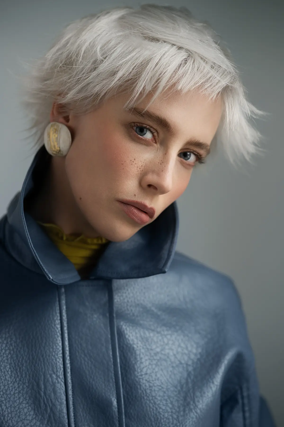 Platinum blonde bixie haircut with textured layers and soft fringe, showcasing edgy short hair trend for summer 2026.