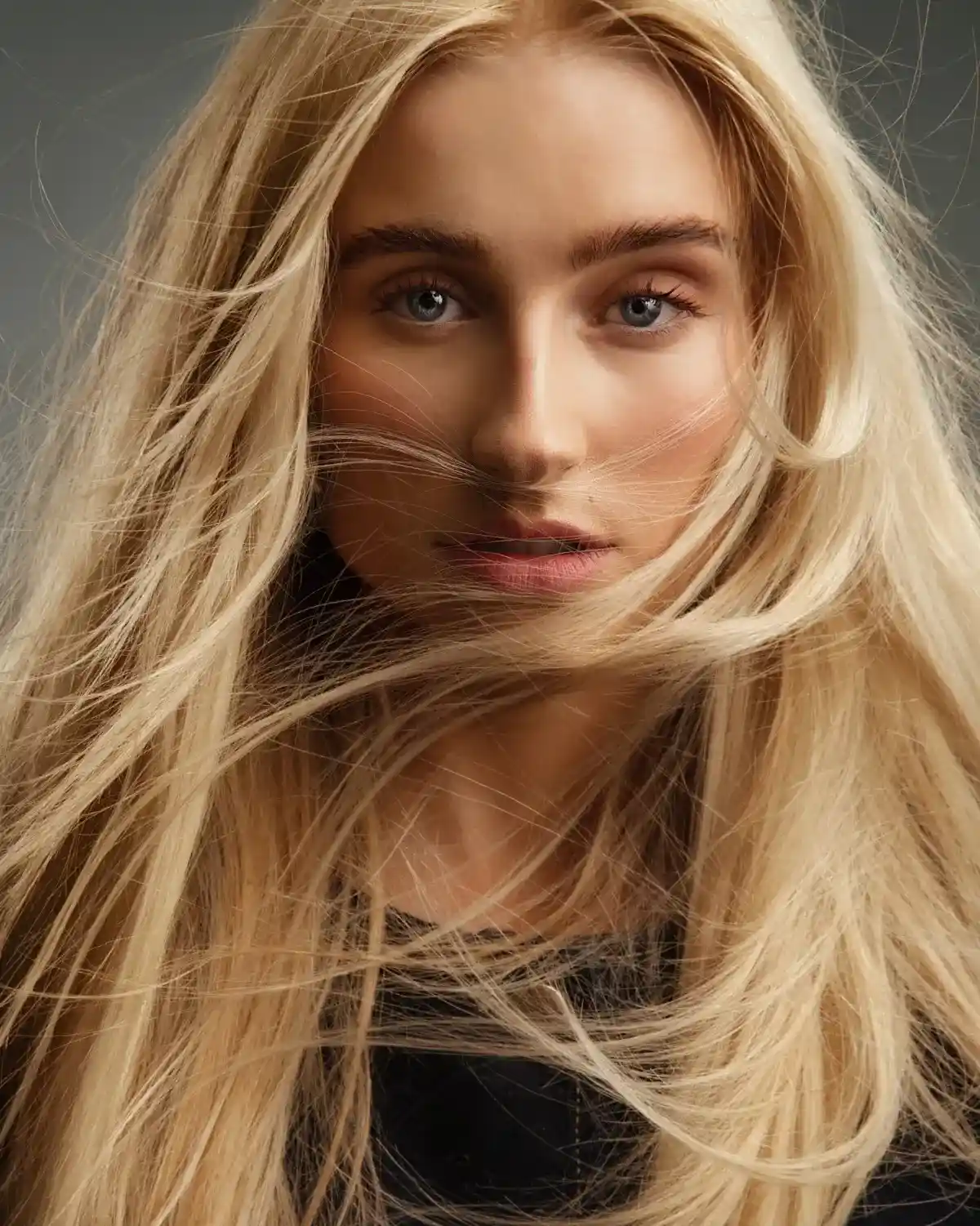 Model with golden hour blonde hair featuring soft buttery tones, glossy texture and effortless summer movement.