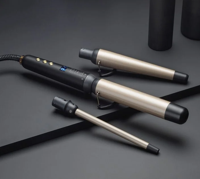 ghd Multi Wand with 2 replaceable head attachments sit on a a black surface.