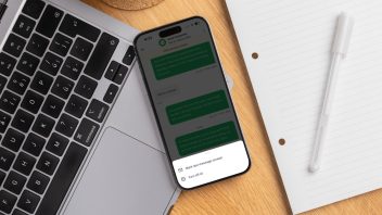 Smartphone displaying AI-powered salon messaging beside a laptop and notepad, highlighting digital client communication and automation.