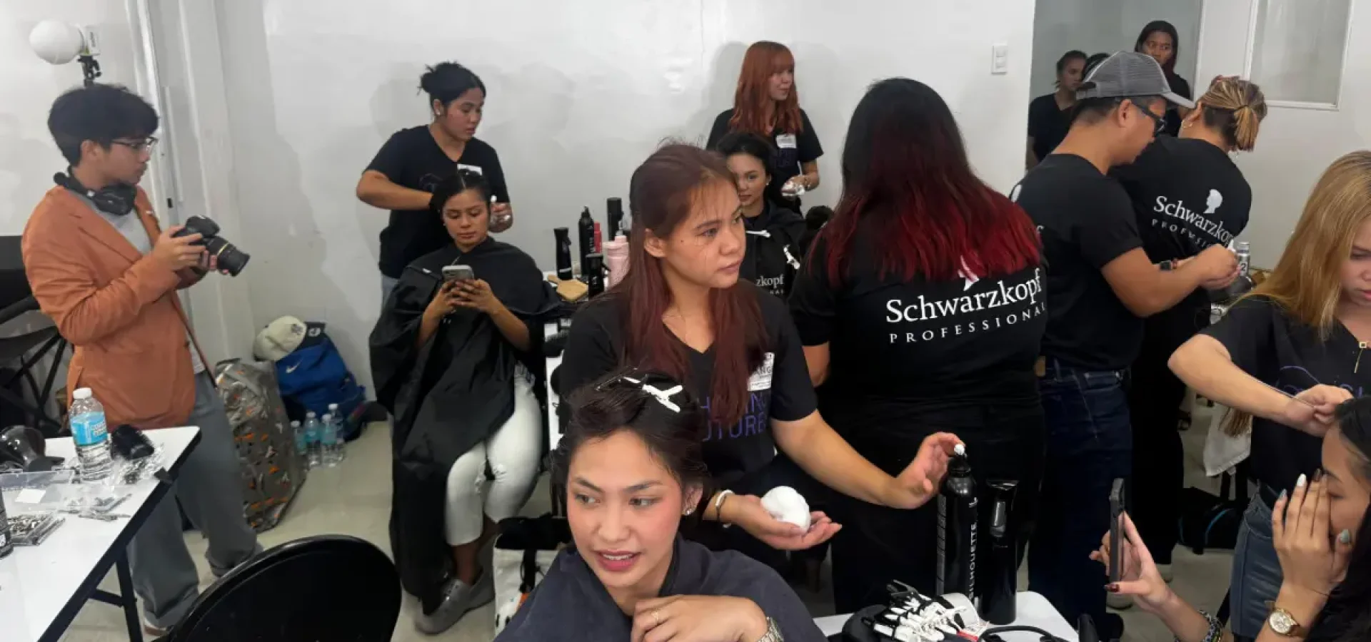 Schwarzkopf Professional Shaping Futures Philippines programme, with educators and students gaining hands-on hairdressing training backstage.