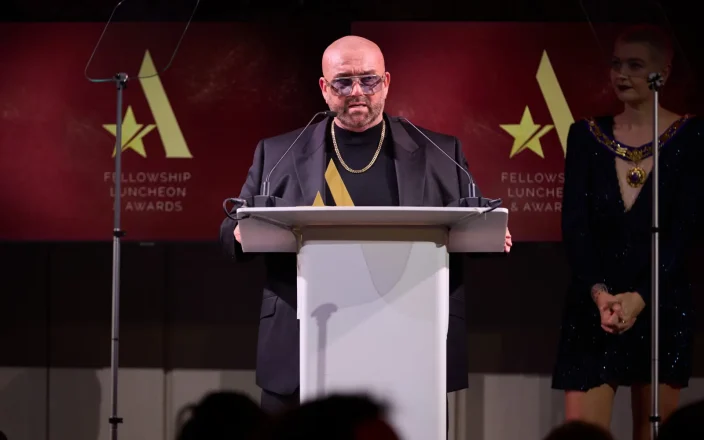 Speaker addresses guests at the Fellowship for British Hairdressing Luncheon & Awards, celebrating industry excellence and achievement.