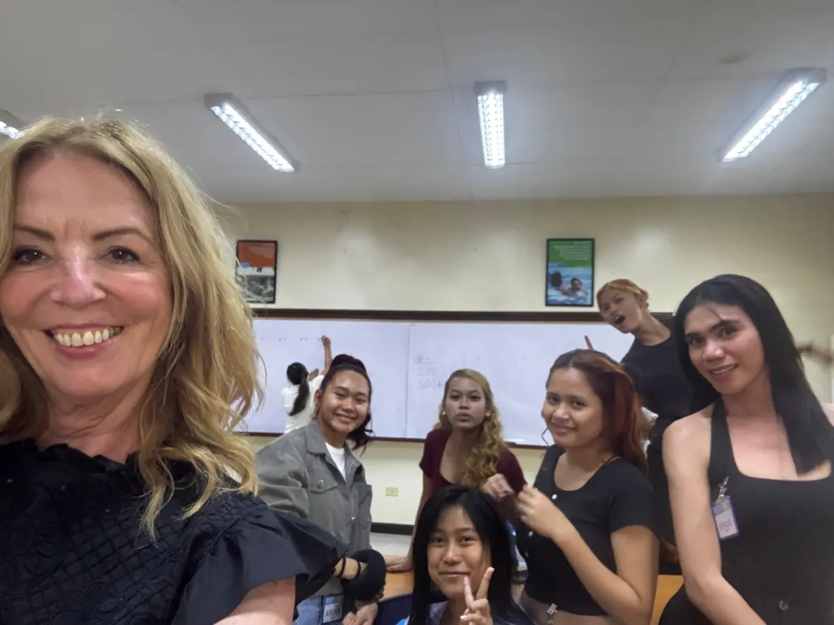 Schwarzkopf Professional Ambassador Suzie McGill with Shaping Futures students in the Philippines during hairdressing education and training.