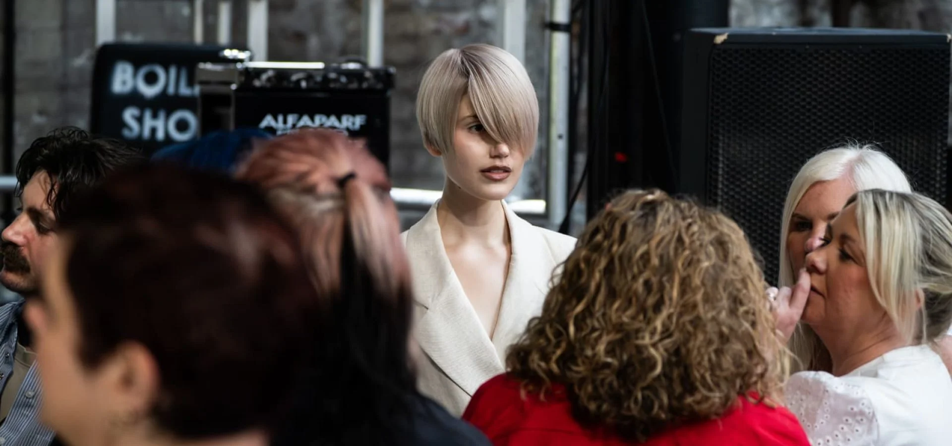 Hair professionals view a live blonde hair colour demonstration at Jamie Benny's ALFAPARF Milano Professional education event.