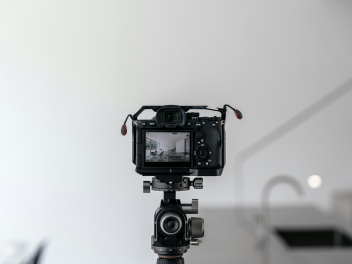 Black and white image of a camera on a photo-shoot.