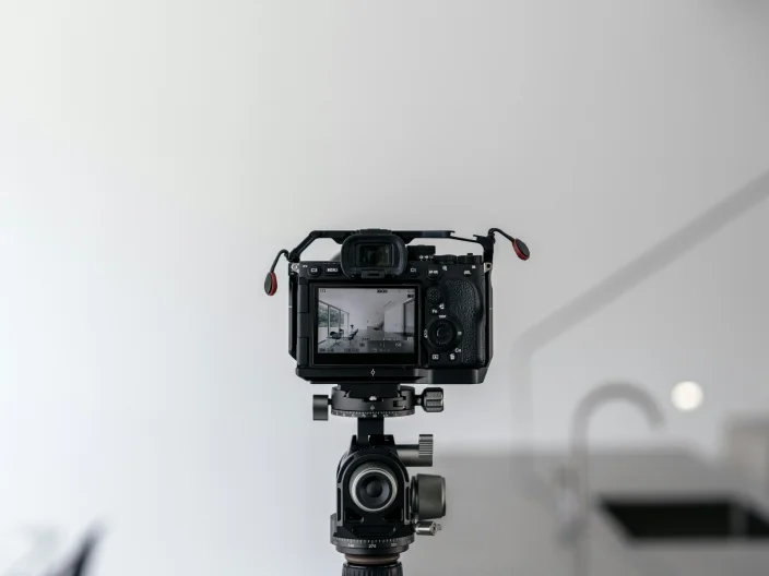 Black and white image of a camera on a photo-shoot.