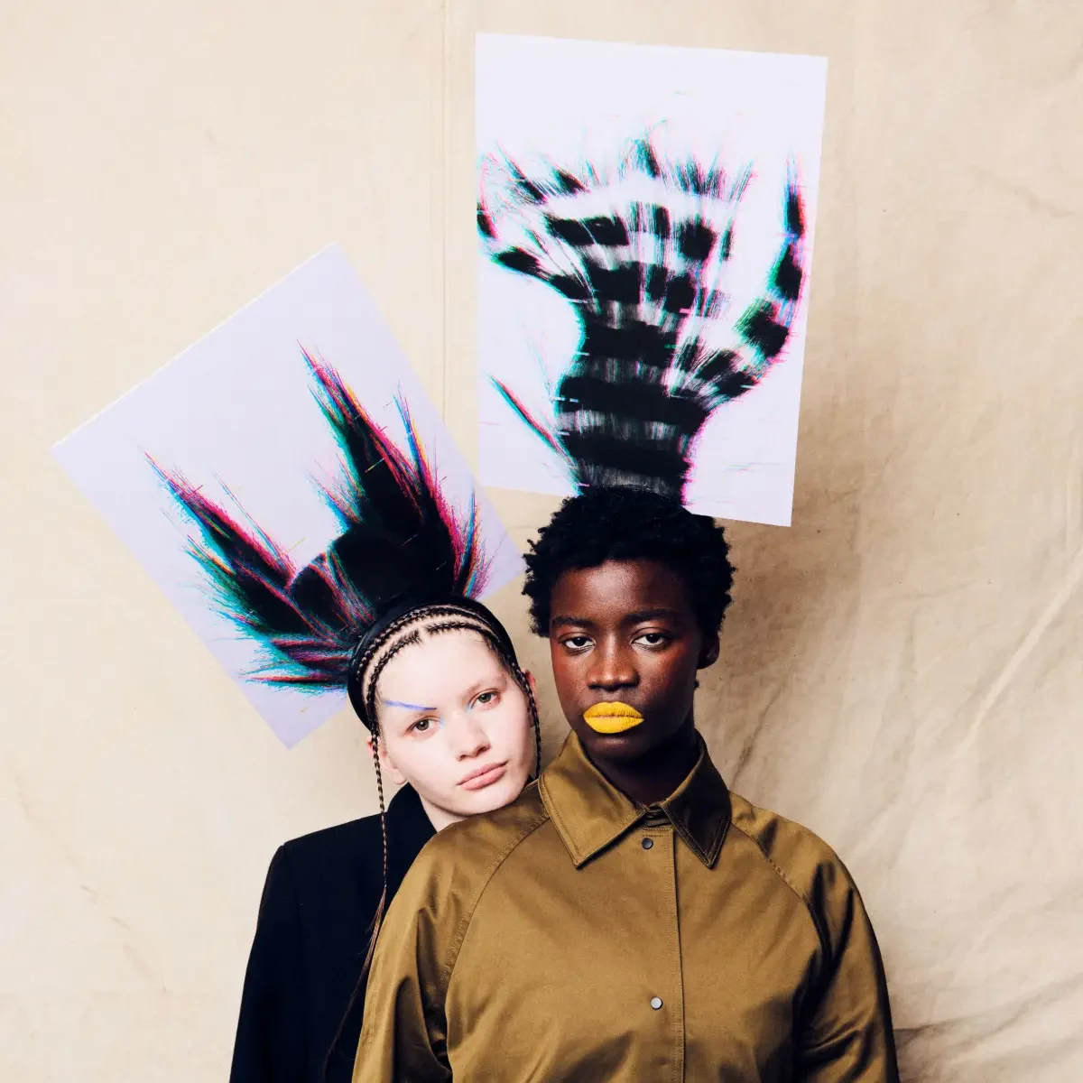 Editorial hair collection featuring two models with avant-garde textured hairstyles, bold makeup and artistic fashion styling.