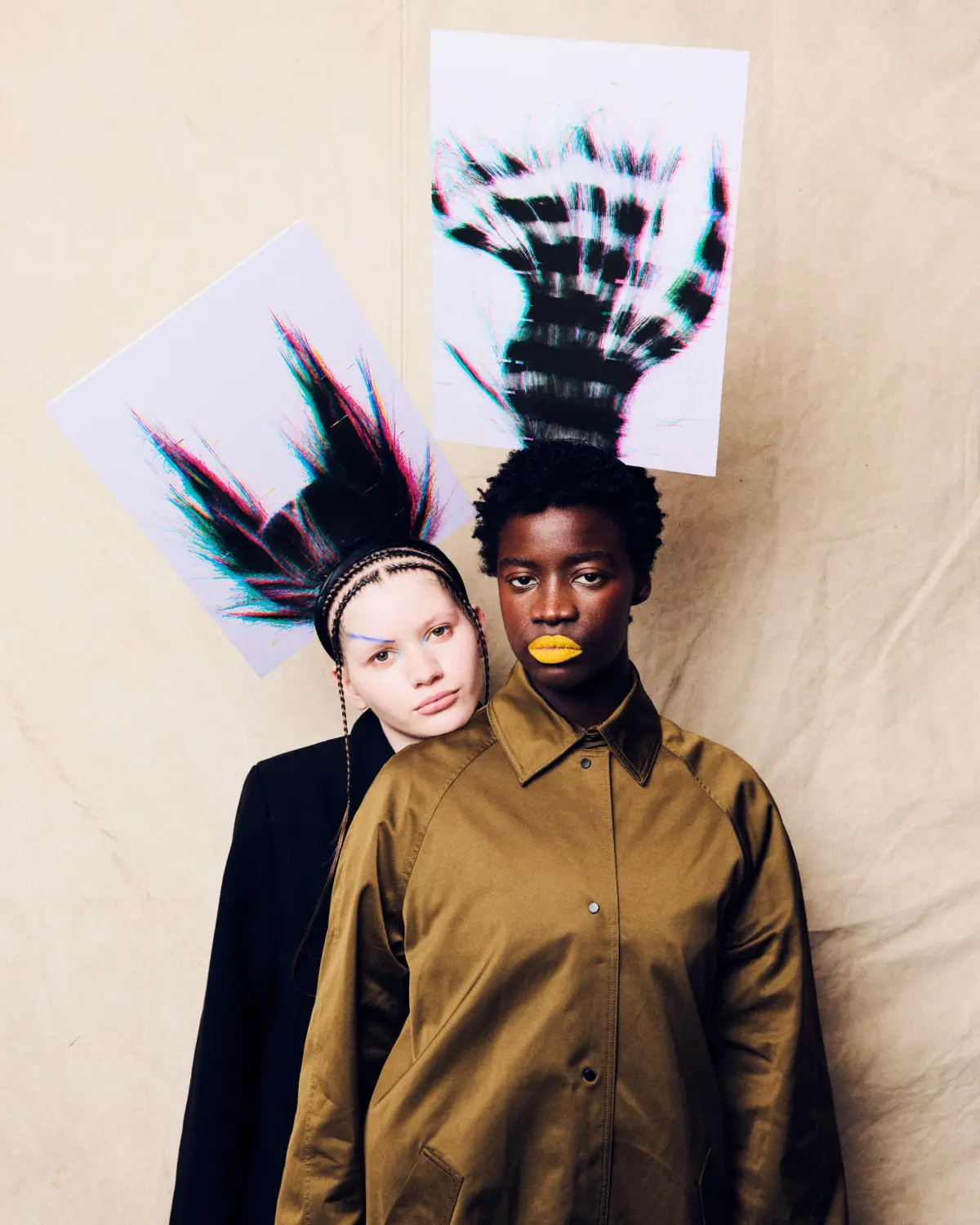 Editorial hair collection featuring two models with avant-garde textured hairstyles, bold makeup and artistic fashion styling.