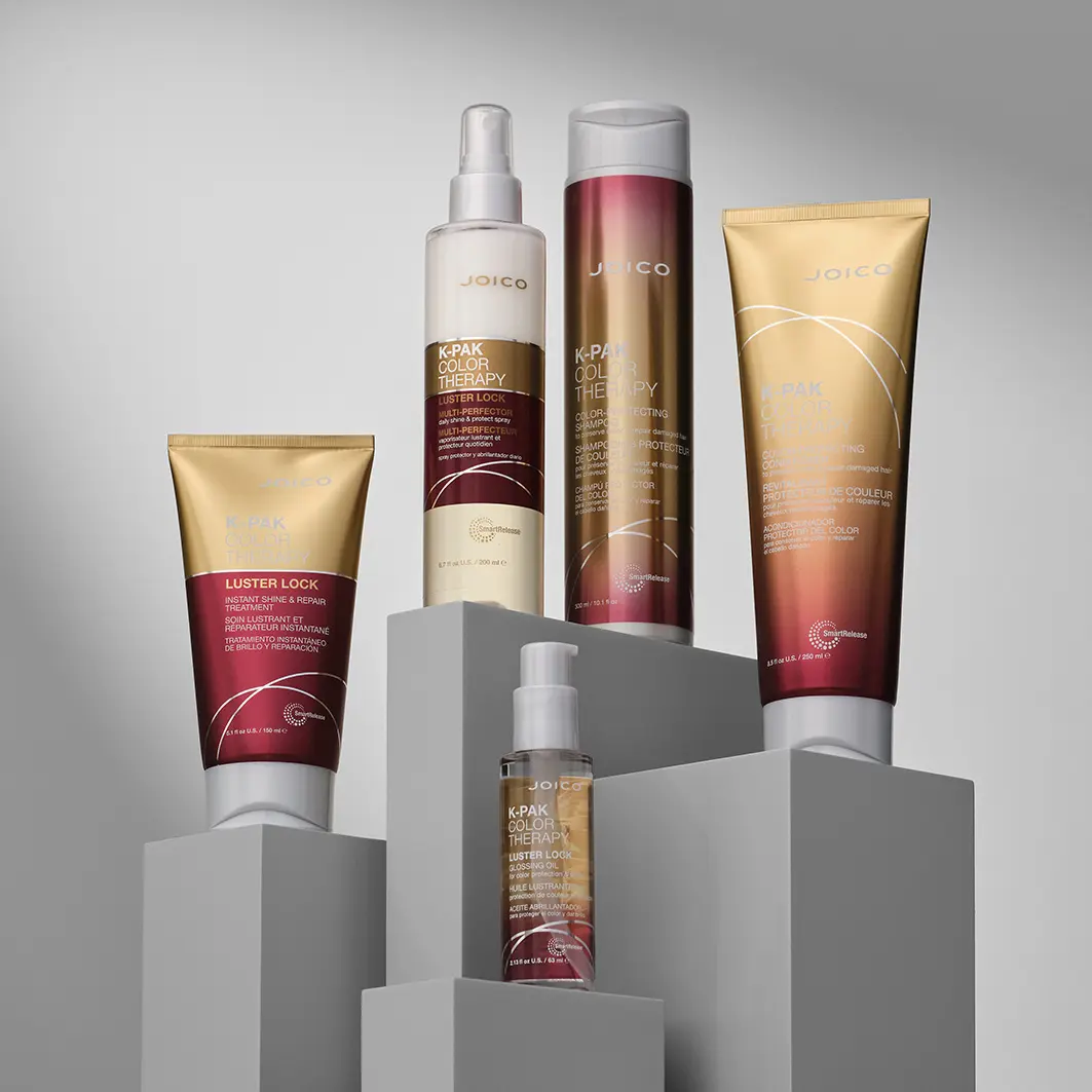 JOICO K-PAK Color Therapy shampoo, conditioner and treatments displayed on minimalist pedestals.