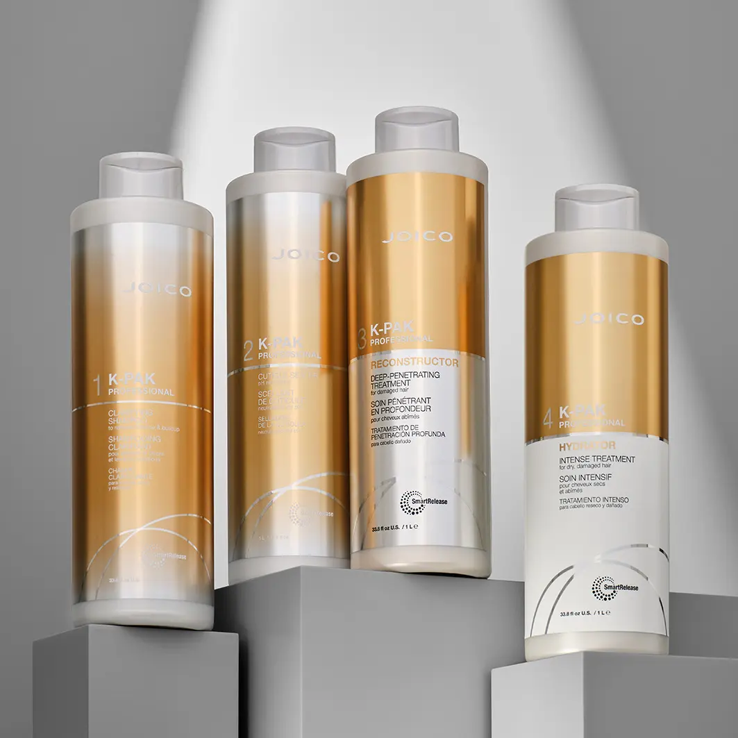 JOICO K-PAK Professional Hair Repair System four-step treatment displayed on minimalist pedestals.