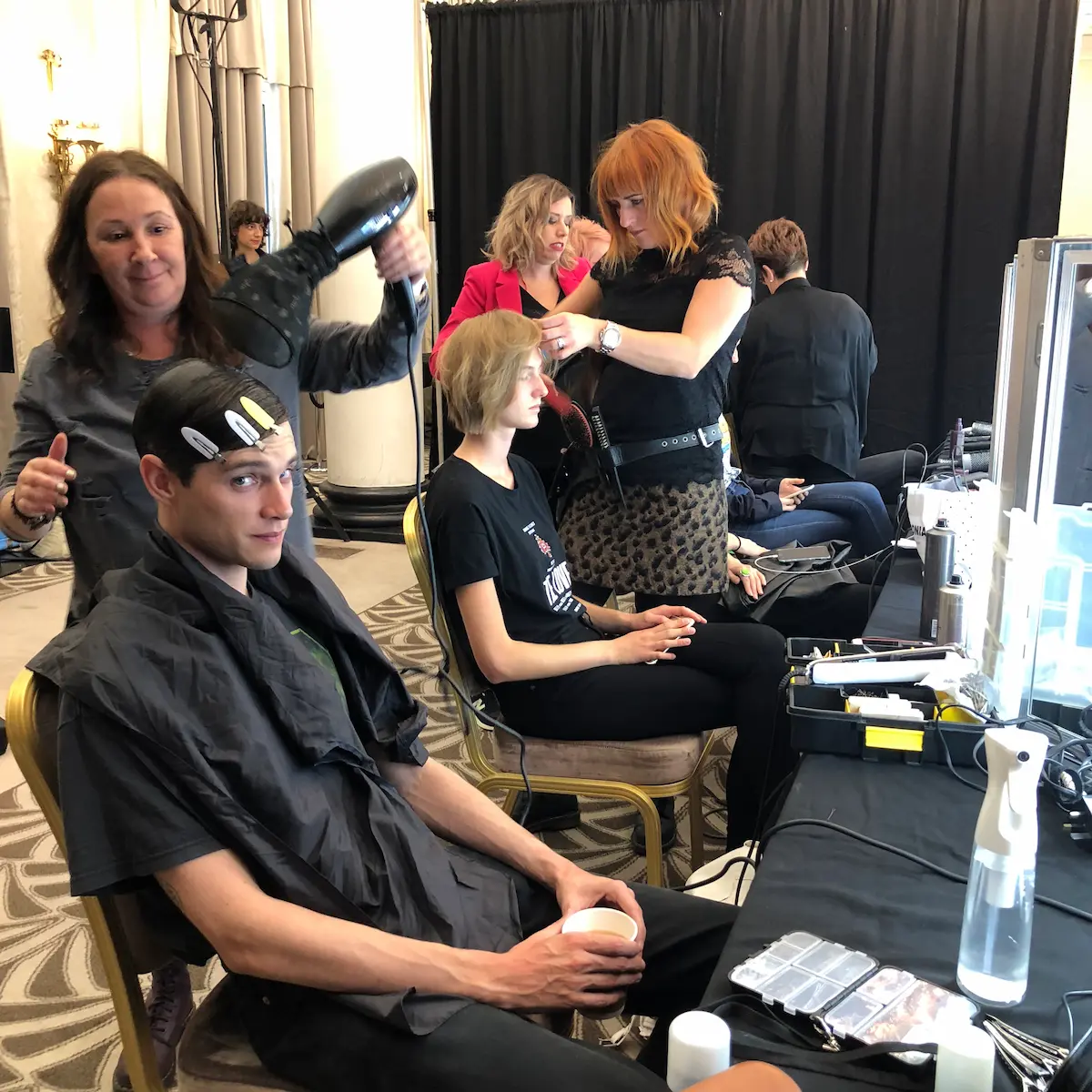 KAM Hairdresser does hair behind the scenes at LFW.