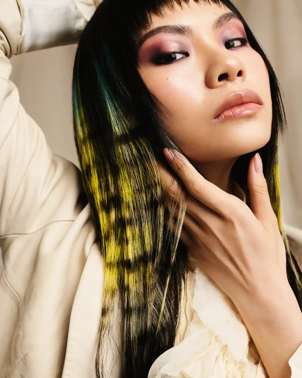 Model with black hair featuring neon yellow colour panels, showcasing the 2026 festival hair trend by Rainbow Room International.