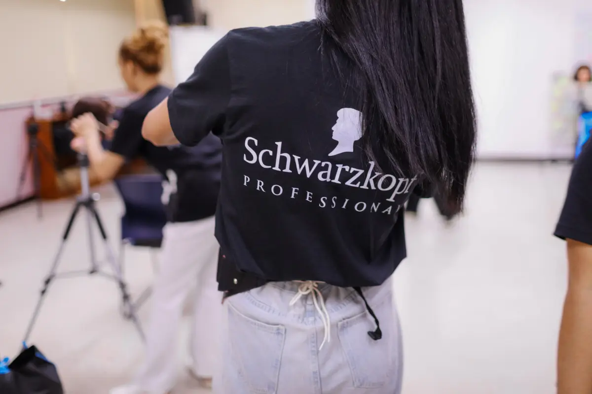 A Schwarzkopf Professional hairdresser demonstrates on a model.