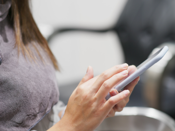 woman on mobile in a salon
