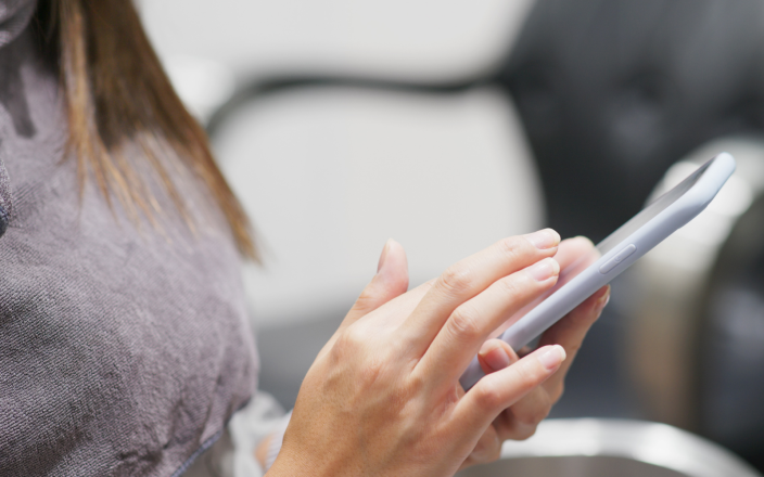 woman on mobile in a salon