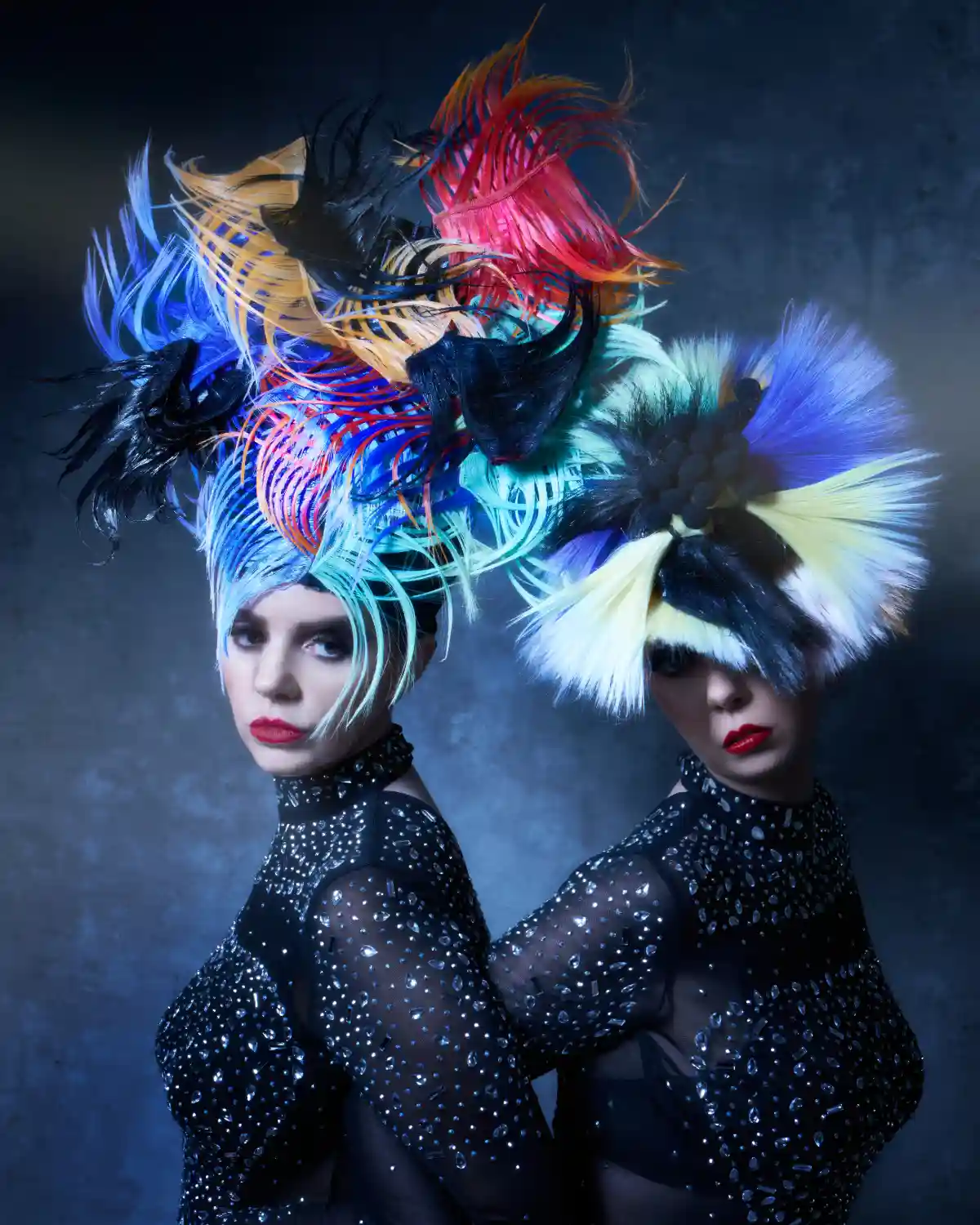 Two models with colourful feathery headdresses from the collection 'ANGELS’ by William and Norma Gray.