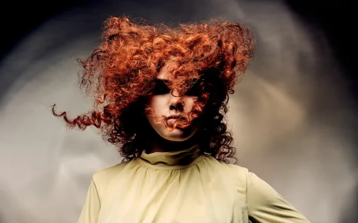 Alex Thaddeus Tempest Collection featuring voluminous copper curls styled to capture movement through the atmosphere.