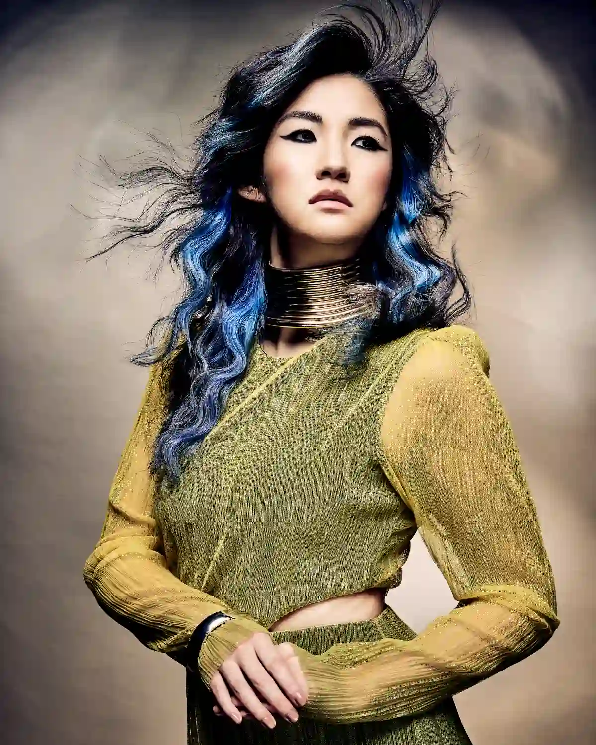Tempest Collection by Alex Thaddeus featuring long, wavy black hair with vivid blue accents, styled to evoke movement through the atmosphere.