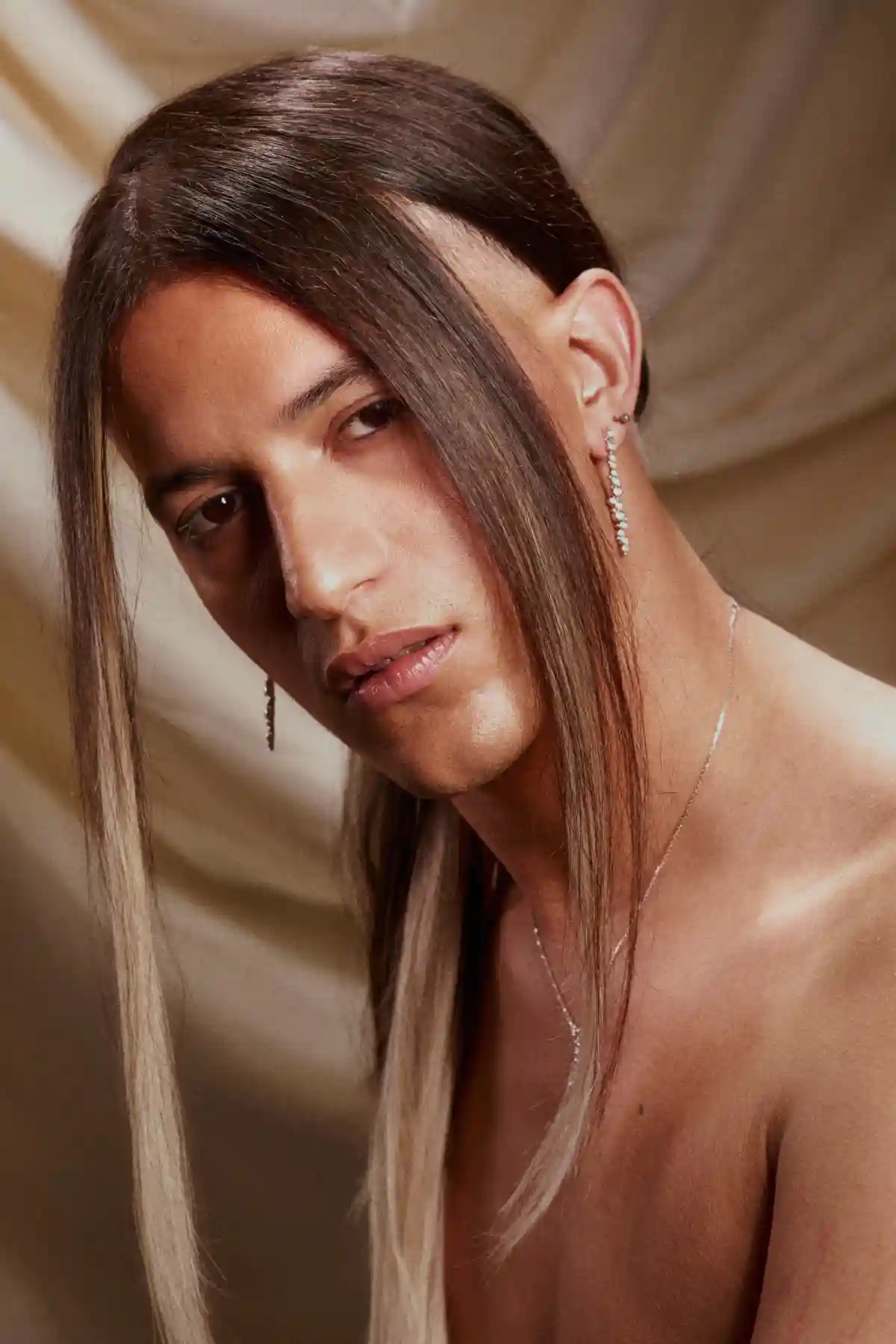 Model with long brown hair tied back with parted fringe as part of the Archangels collection by Grant Carr.