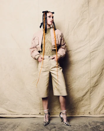 Model with long orange ribbon braids and editorial styling from the 2026 F.A.M.E Team CounterCulture hair collection.