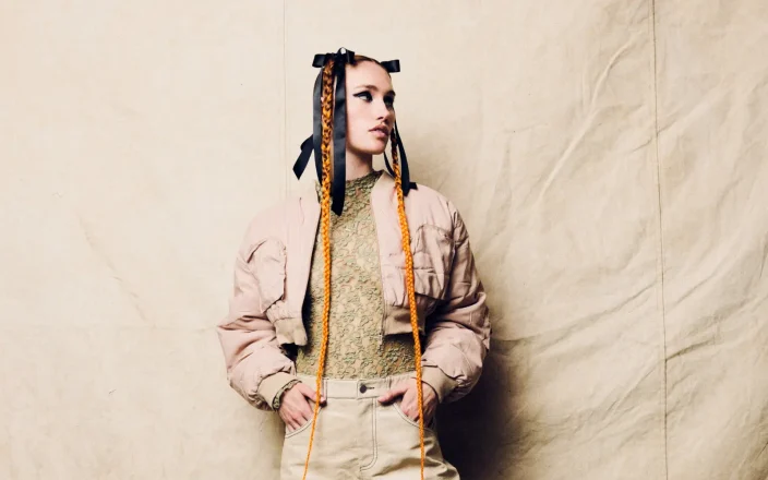 Model with long orange ribbon braids and editorial styling from the 2026 F.A.M.E Team CounterCulture hair collection.