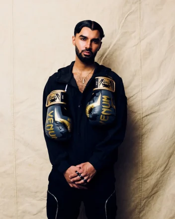 Project Men and Media’s Archetype collection featuring a model in black with gold and black Venum boxing gloves.