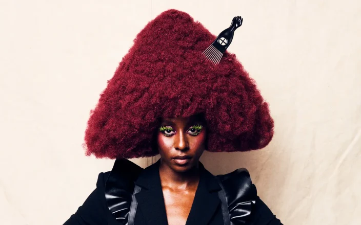 Model with sculptural burgundy Afro hairstyle from Project Afro 2026's The Crown: A Journey Through Texture collection.