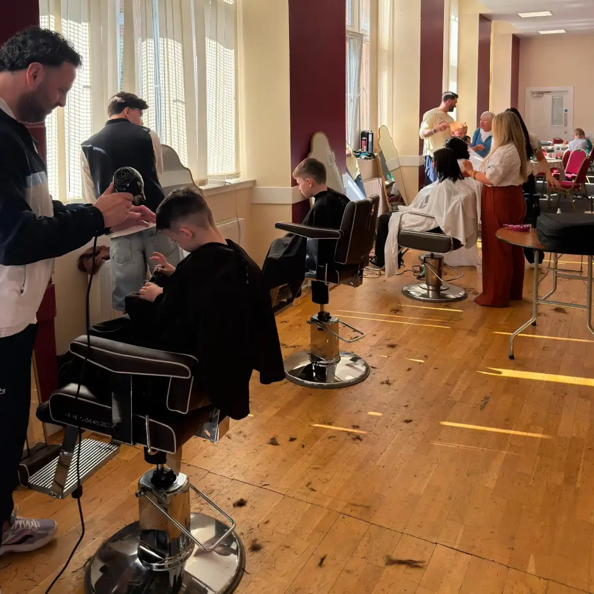 Hairdressers from the Grant Carr's Glasgow salon cut kids hair at a back to school event.