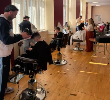 Hairdressers from the Grant Carr's Glasgow salon cut kids hair at a back to school event.