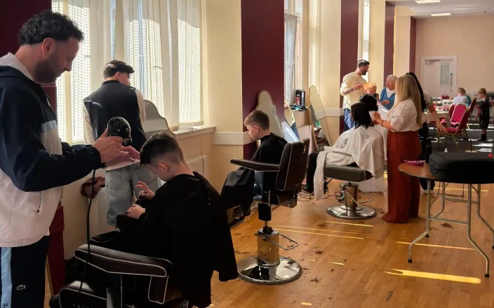 Hairdressers from the Grant Carr's Glasgow salon cut kids hair at a back to school event.
