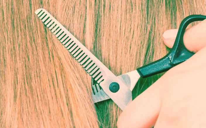 Close up of scissors cutting hair.