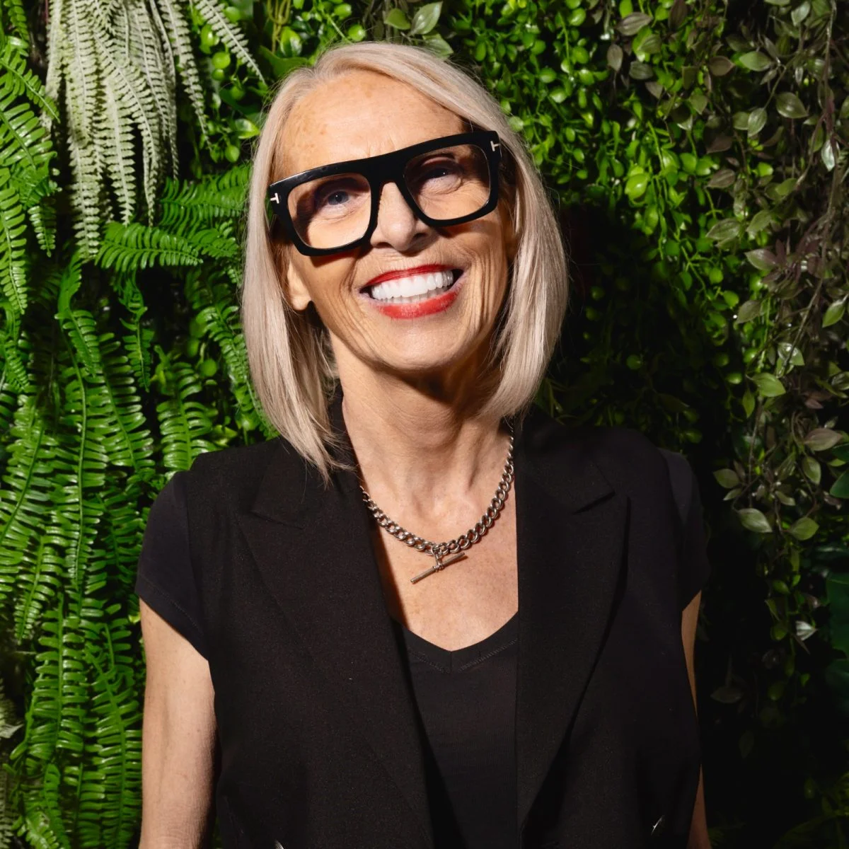 Marlene lamont stands in front of a living wall.