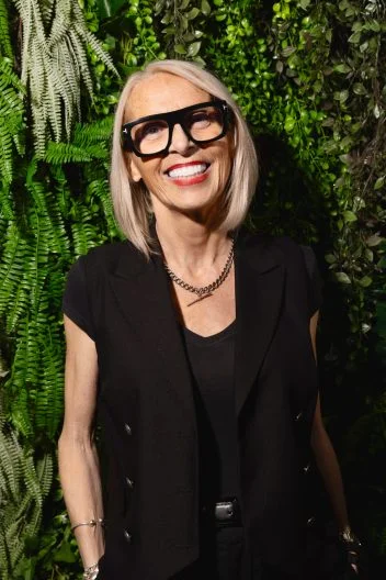 Marlene lamont stands in front of a living wall.