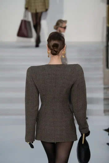 Behind a model with brown hair at Paul Costelloe AW26.