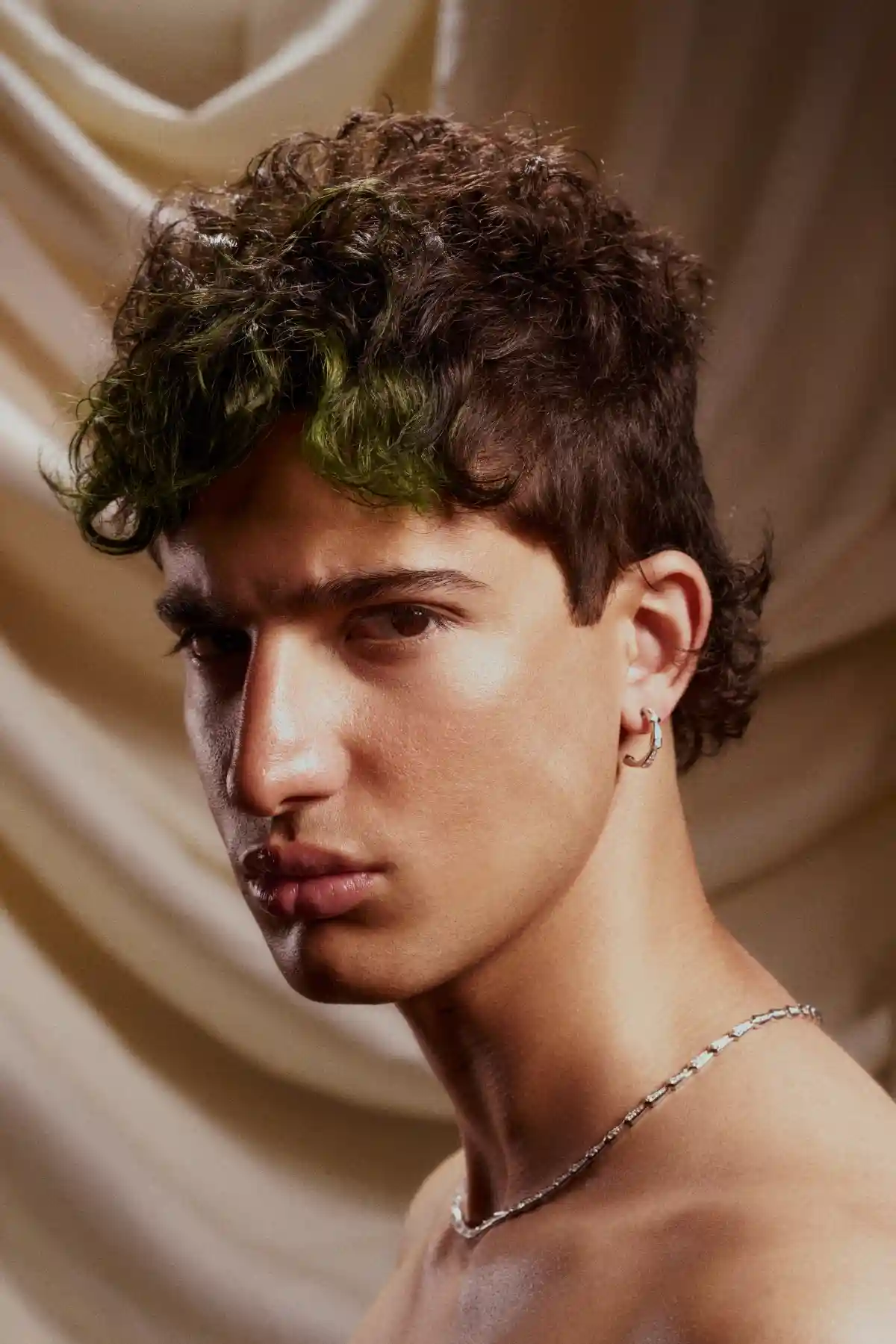 Model with short brown hair with green highlights in the fringe as part pf the Archangels collection by Grant Carr.