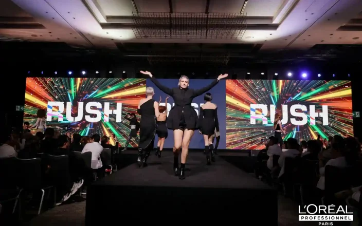 Model with blonde hair in the centre of the RUSH event stage.