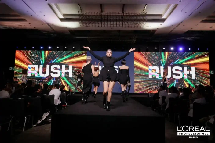 Model with blonde hair in the centre of the RUSH event stage.