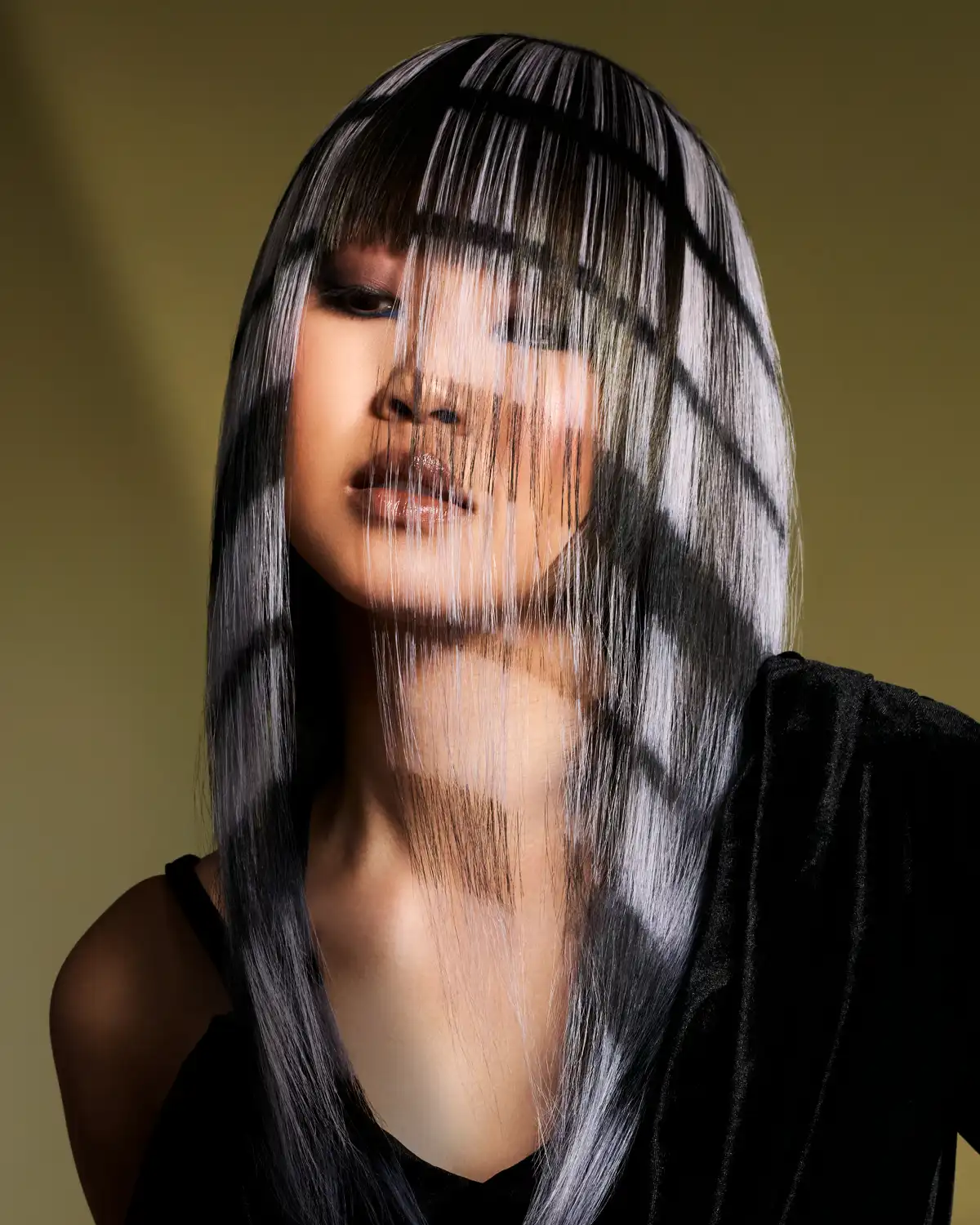 Karen Thomson’s Into The Light collection featuring sleek black hair with graphic, layered fringe and striking geometric sections.