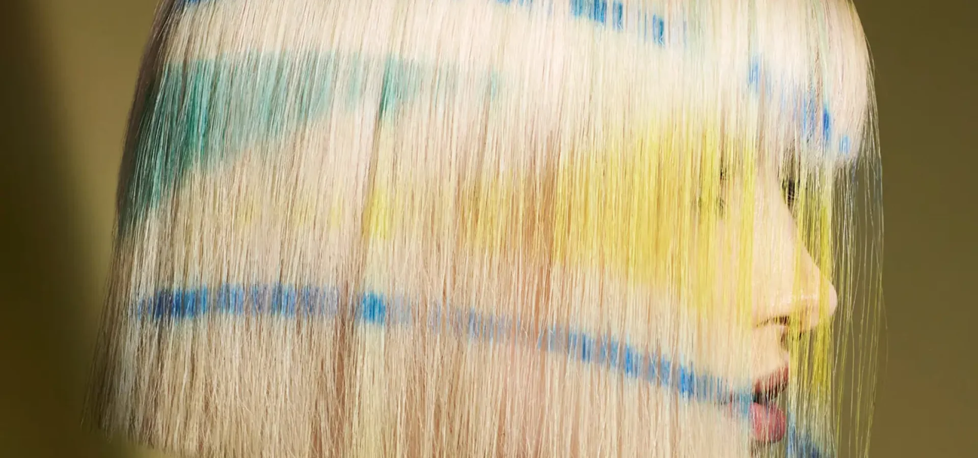 Karen Thomson Into The Light collection featuring a blonde bob with blue, green and yellow graphic colour accents.