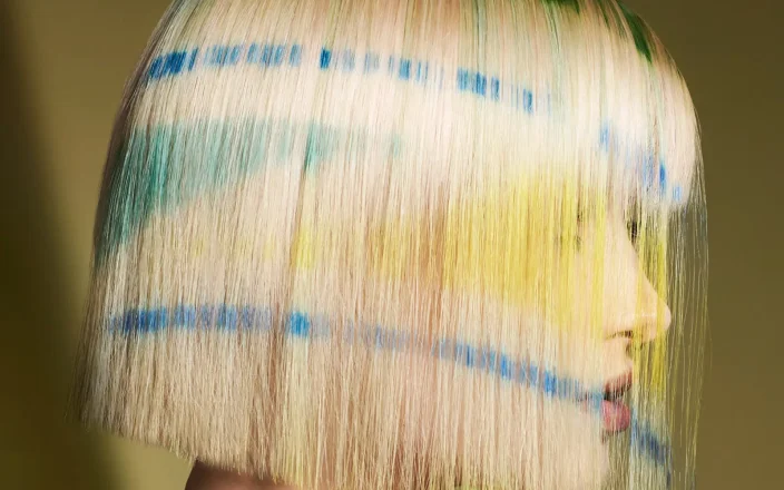Karen Thomson Into The Light collection featuring a blonde bob with blue, green and yellow graphic colour accents.
