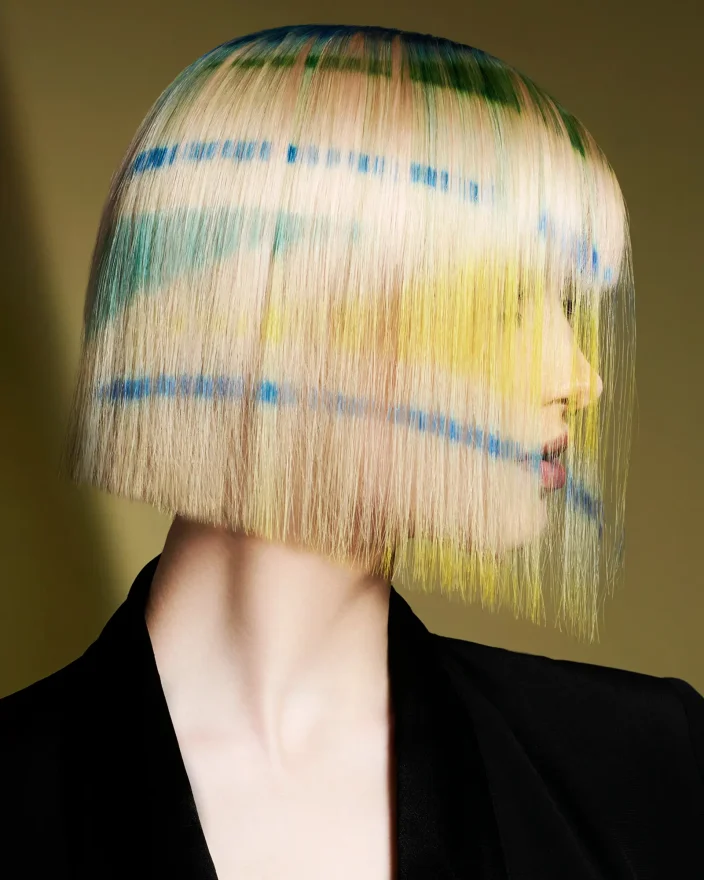 Karen Thomson Into The Light collection featuring a blonde bob with blue, green and yellow graphic colour accents.