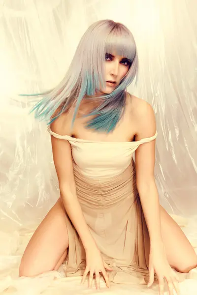Model with a sleek silver-blonde bob featuring soft blue-green tones through the ends from the Solstice collection by Safy Burton, inspired by the shifting colours of sunrise and sunset skies with fluid movement, softness and luminous colour.