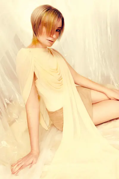 Model with a short blonde and golden-toned hairstyle from the Solstice collection by Safy Burton, featuring soft layered movement and luminous colour inspired by the shifting tones of sunrise and sunset skies.